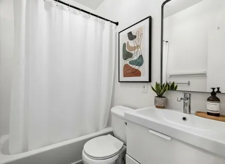 a bathroom with a toilet a sink and a mirror