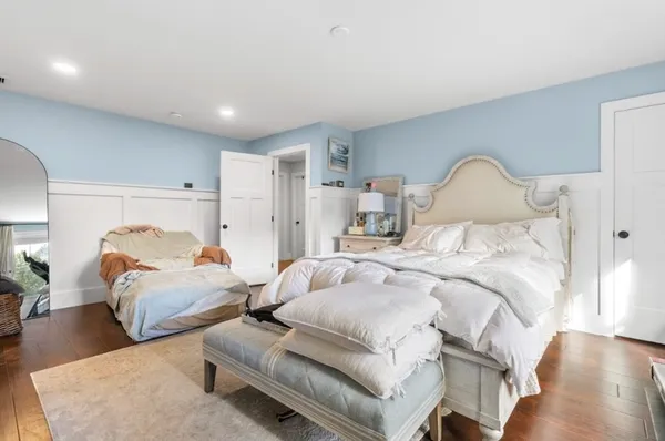 a bedroom with two beds and a dresser