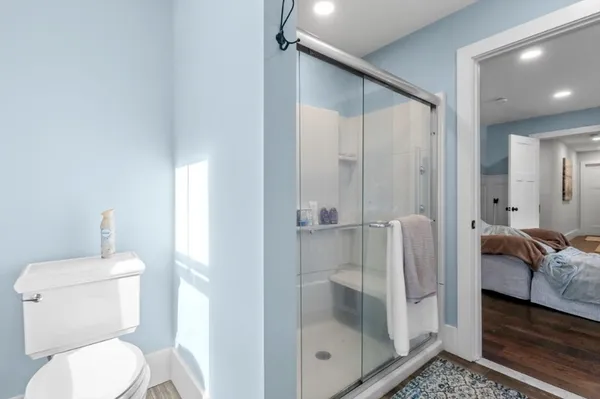 a bathroom with a toilet and a shower