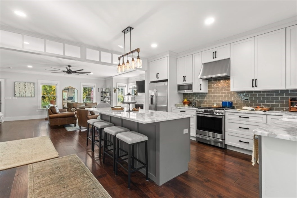 90 Walnut Road North Attleboro, MA 02760 - Photo 2 of 38 a kitchen with stainless steel appliances kitchen island granite countertop a sink dishwasher a stove a refrigerator and cabinets with wooden floor