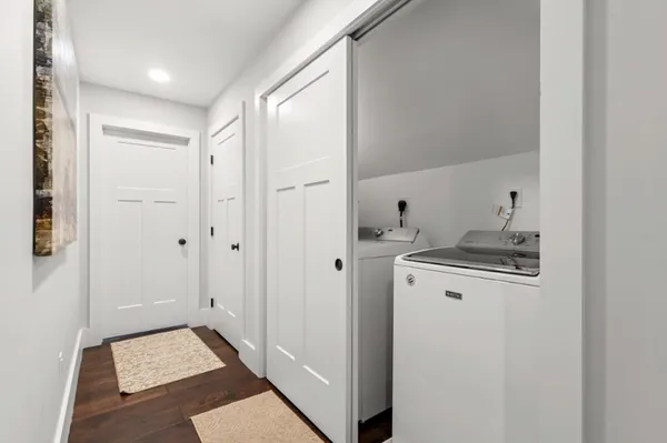 a hallway with washer and dryer