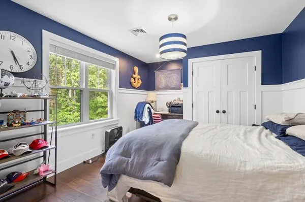 a bedroom with a bed and a large window