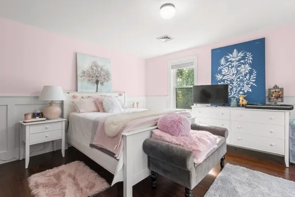 a bedroom with a bed a couch and dresser