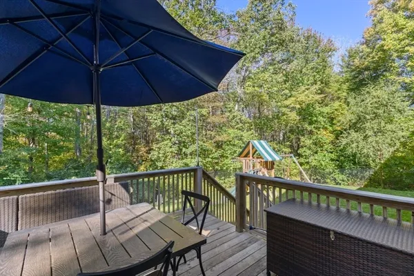 a view of a deck with wooden floor and barbeque oven