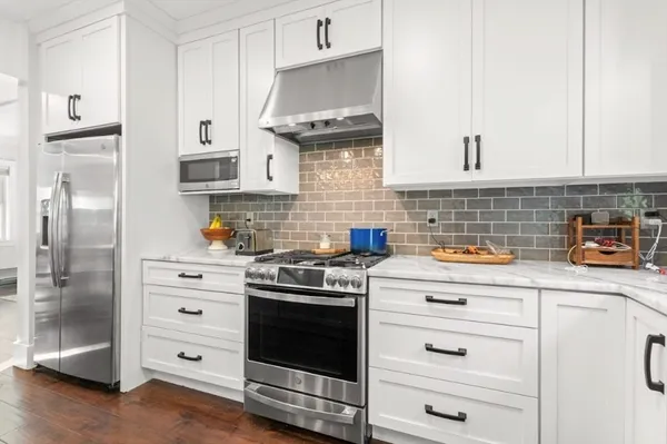 a kitchen with stainless steel appliances a stove and refrigerator