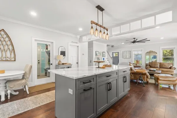 a large kitchen with lots of counter space and painting on the wall