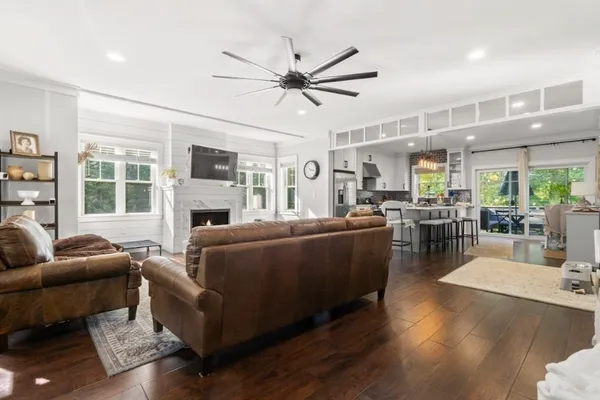 a living room with furniture wooden floor and a fireplace
