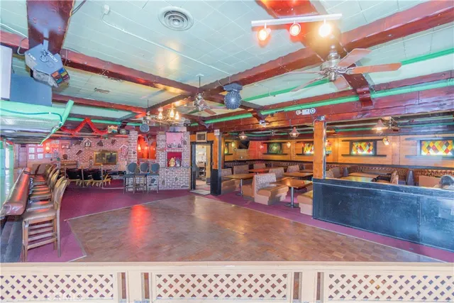 a view of a chairs and car parked