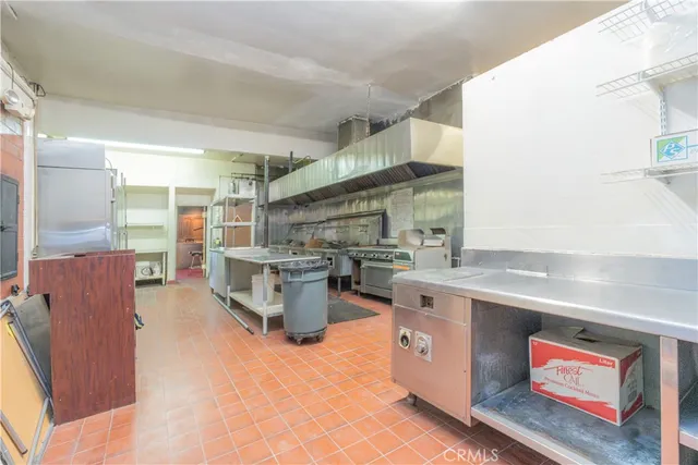 a kitchen with stainless steel appliances granite countertop a stove and a refrigerator