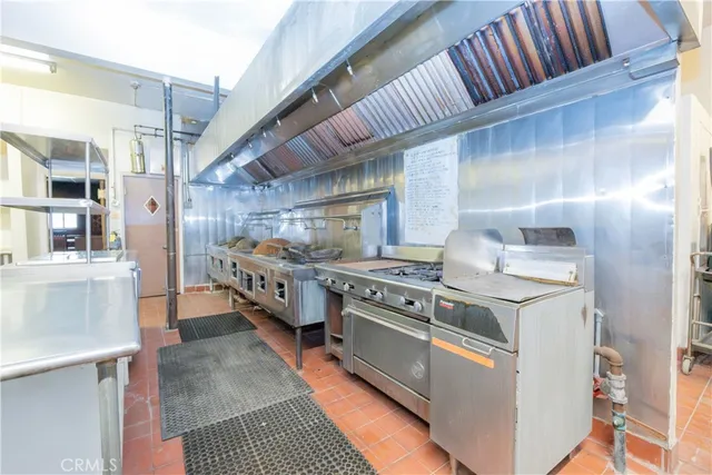 a living room with stainless steel appliances kitchen island granite countertop furniture and a fireplace