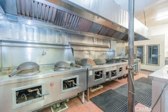 a kitchen with stainless steel appliances granite countertop a stove and a refrigerator