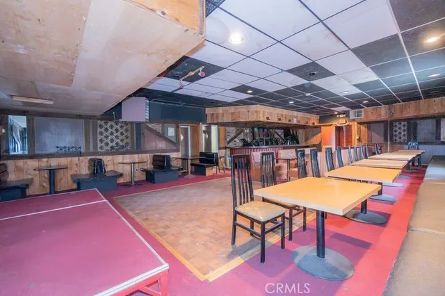 a living room with a bed furniture and a large window