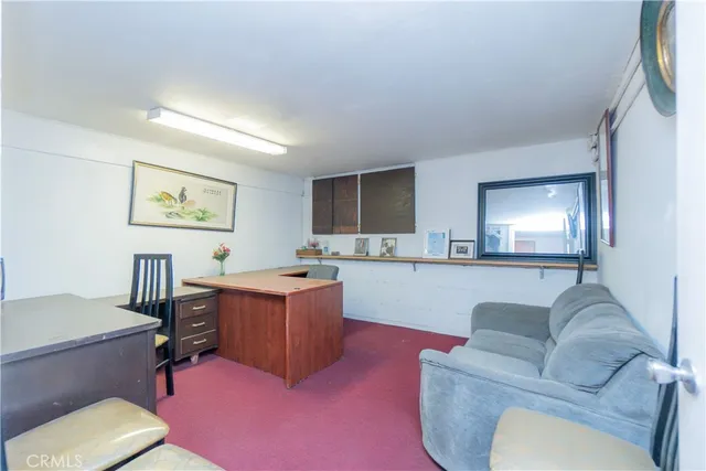 a bed room with a bed and a view of kitchen