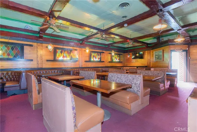 a living room with lots of furniture and kitchen view