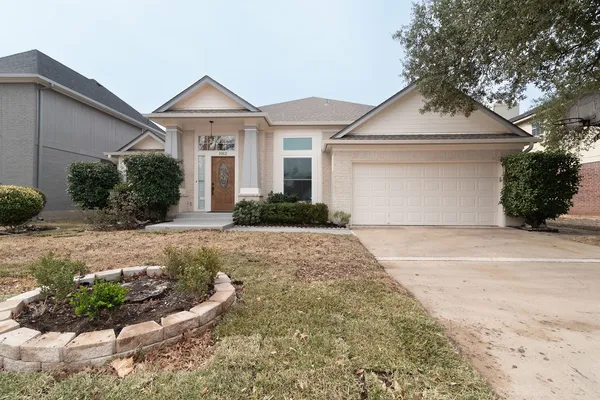 a front view of a house with a yard