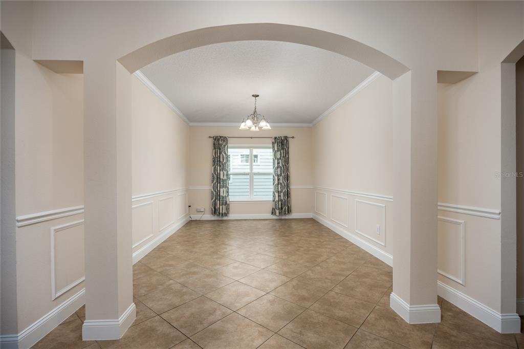 8216 Northwest 54th Street Gainesville, FL 32653 - Photo 17 of 57 an empty room with windows and chandelier fan