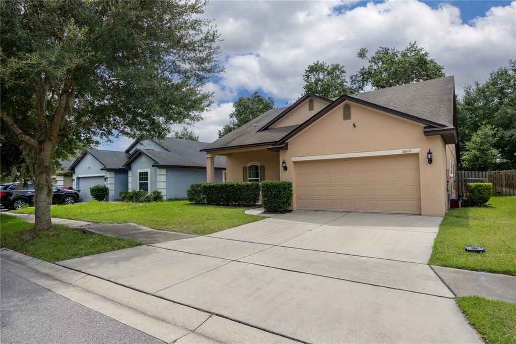 8216 Northwest 54th Street Gainesville, FL 32653 - Photo 2 of 57 a front view of a house with a yard and garage