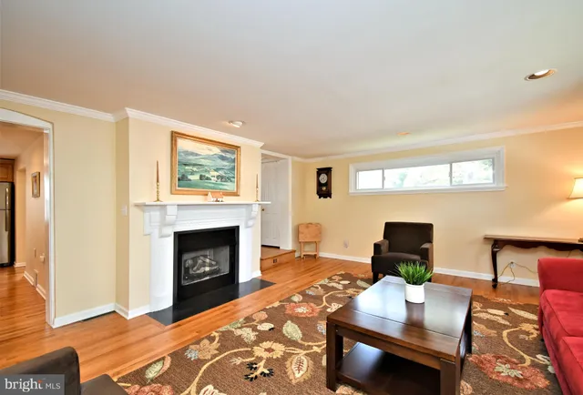 a living room with furniture and a flat screen tv with wooden floor