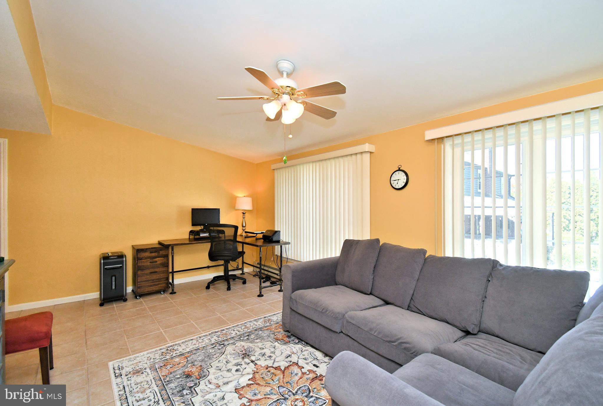 442 Oreland Mill Road Oreland, PA 19075 - Photo 24 of 68 a living room with furniture ceiling fan and a rug
