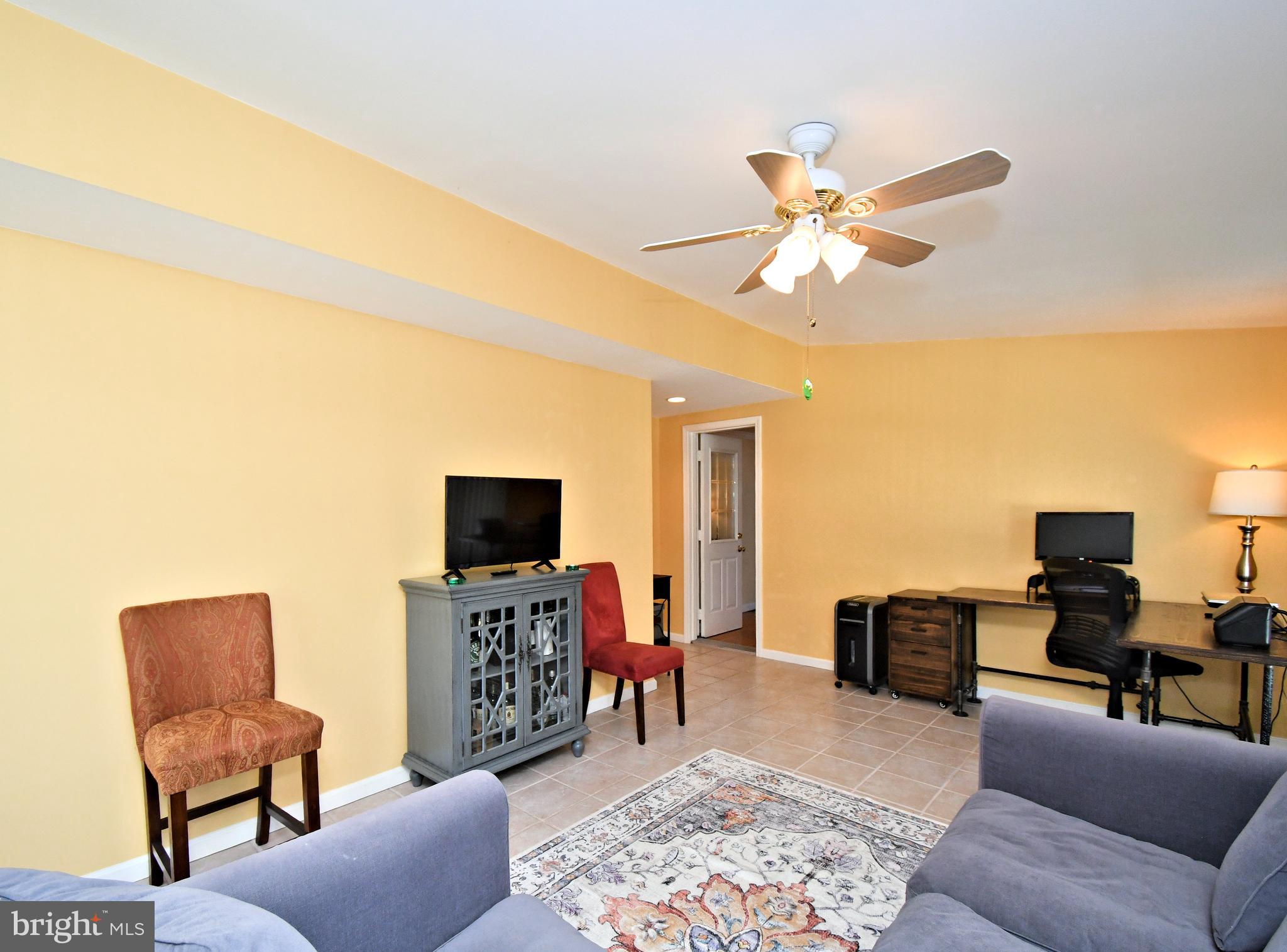 442 Oreland Mill Road Oreland, PA 19075 - Photo 25 of 68 a living room with furniture and a flat screen tv with wooden floor