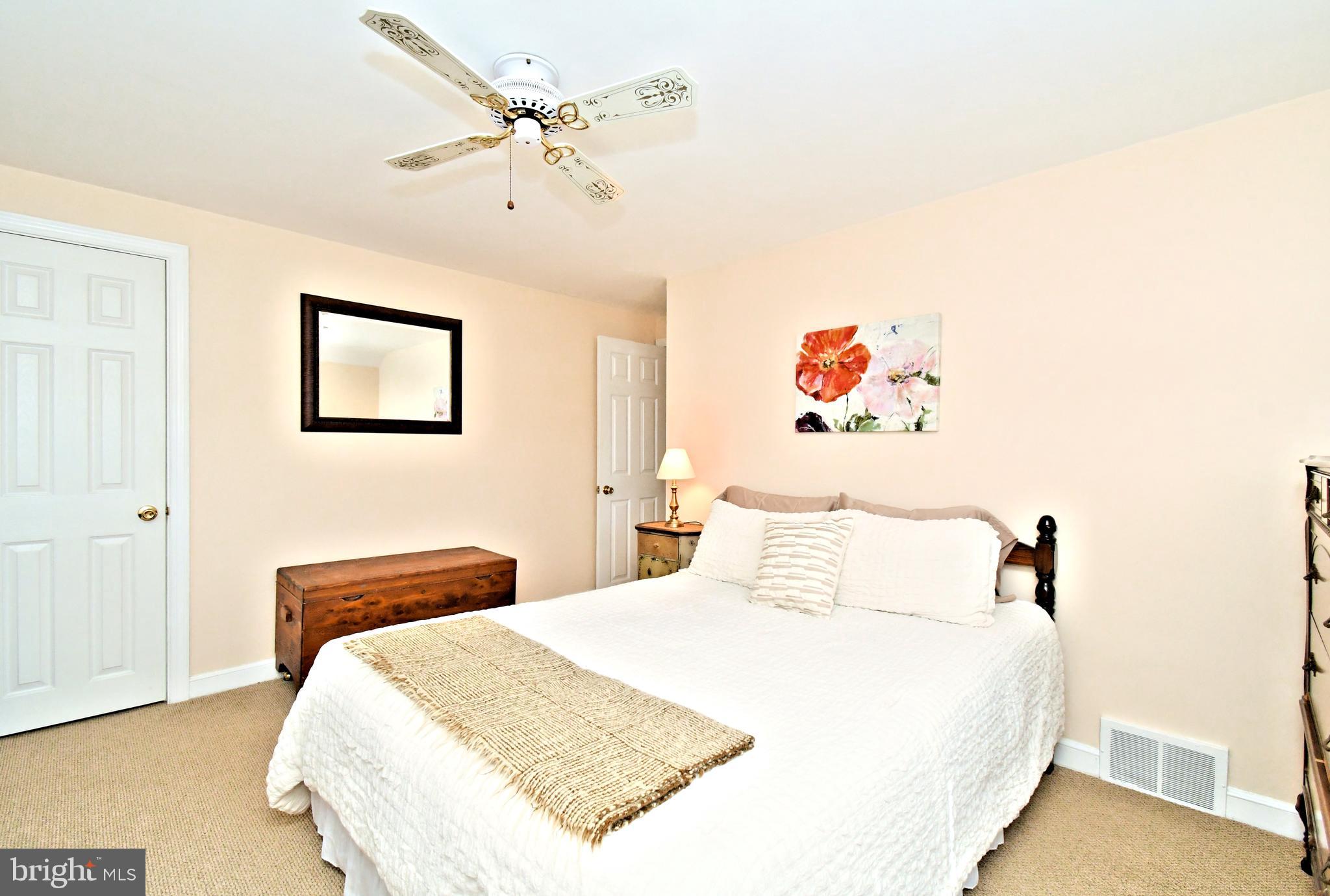 442 Oreland Mill Road Oreland, PA 19075 - Photo 32 of 68 a bedroom with a bed and a chandelier