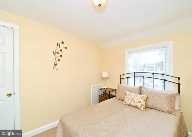 a view of a white house with a big yard and large tree