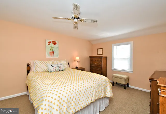 a kitchen with stainless steel appliances granite countertop a sink a stove cabinets counter space and a window