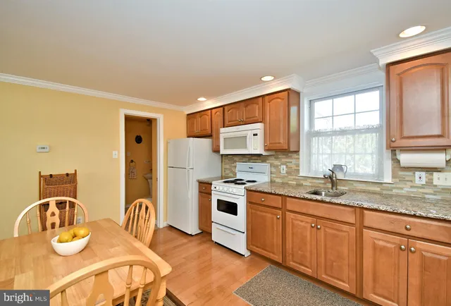 a en suite bathroom with a granite countertop sink and a mirror