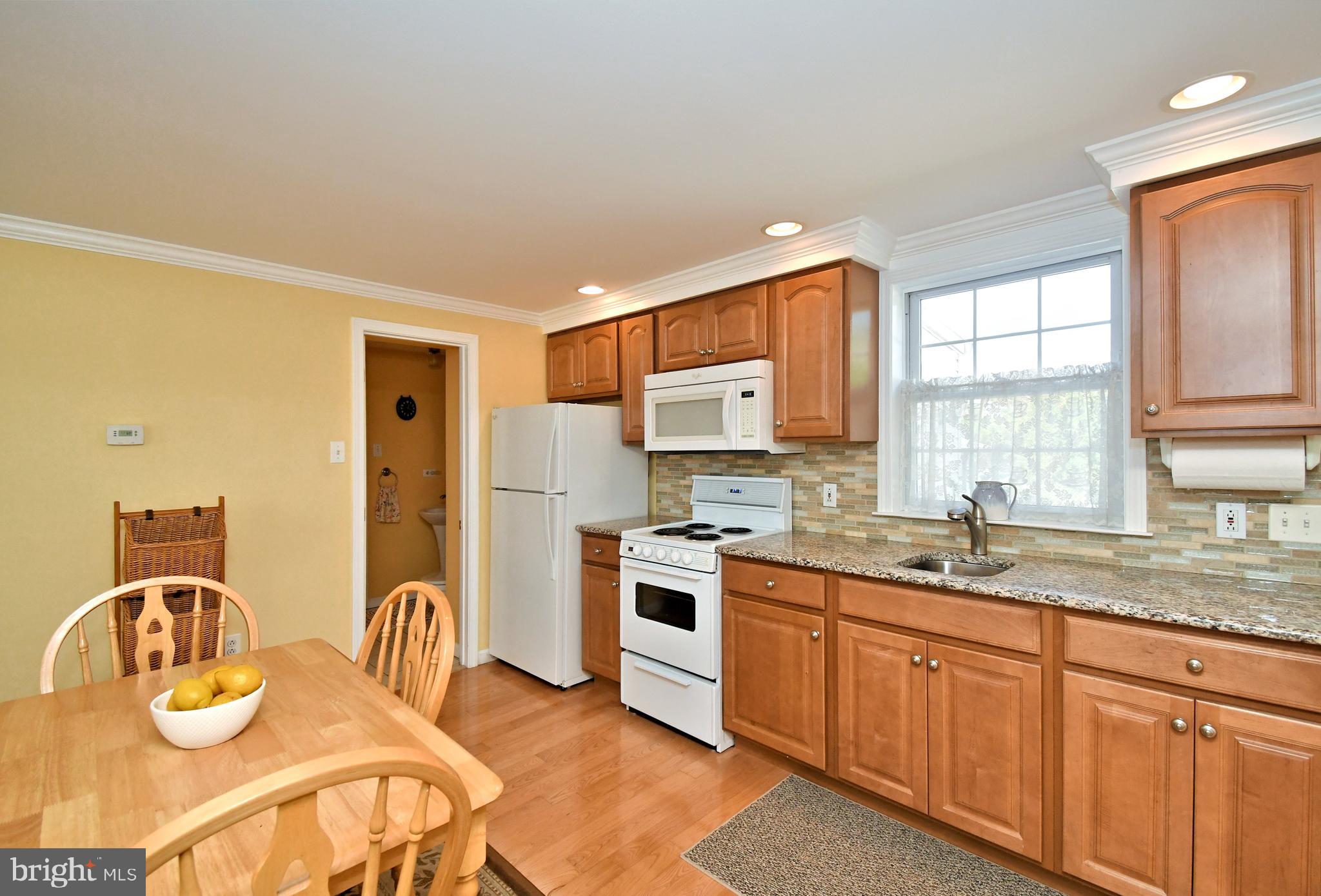 442 Oreland Mill Road Oreland, PA 19075 - Photo 44 of 68 a kitchen with stainless steel appliances granite countertop a sink a stove cabinets counter space and a window