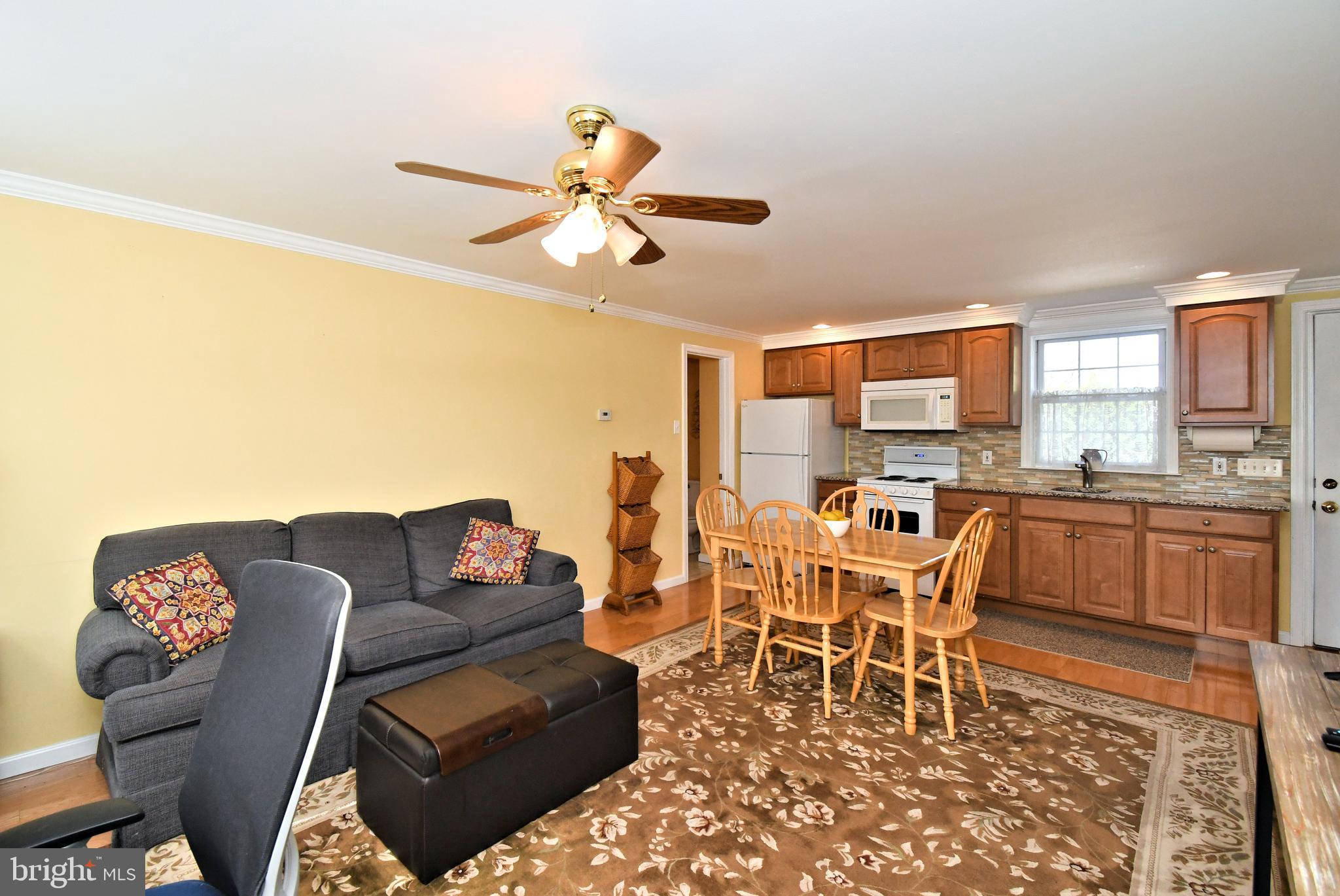 442 Oreland Mill Road Oreland, PA 19075 - Photo 48 of 68 a living room with furniture a dining table and a stove top oven