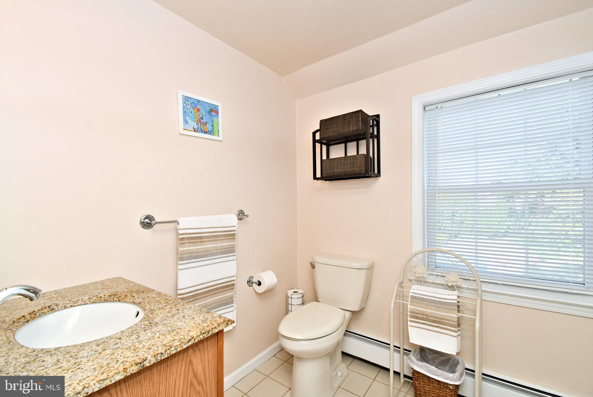 442 Oreland Mill Road Oreland, PA 19075 - Photo 53 of 68 a bathroom with a granite countertop toilet sink and mirror