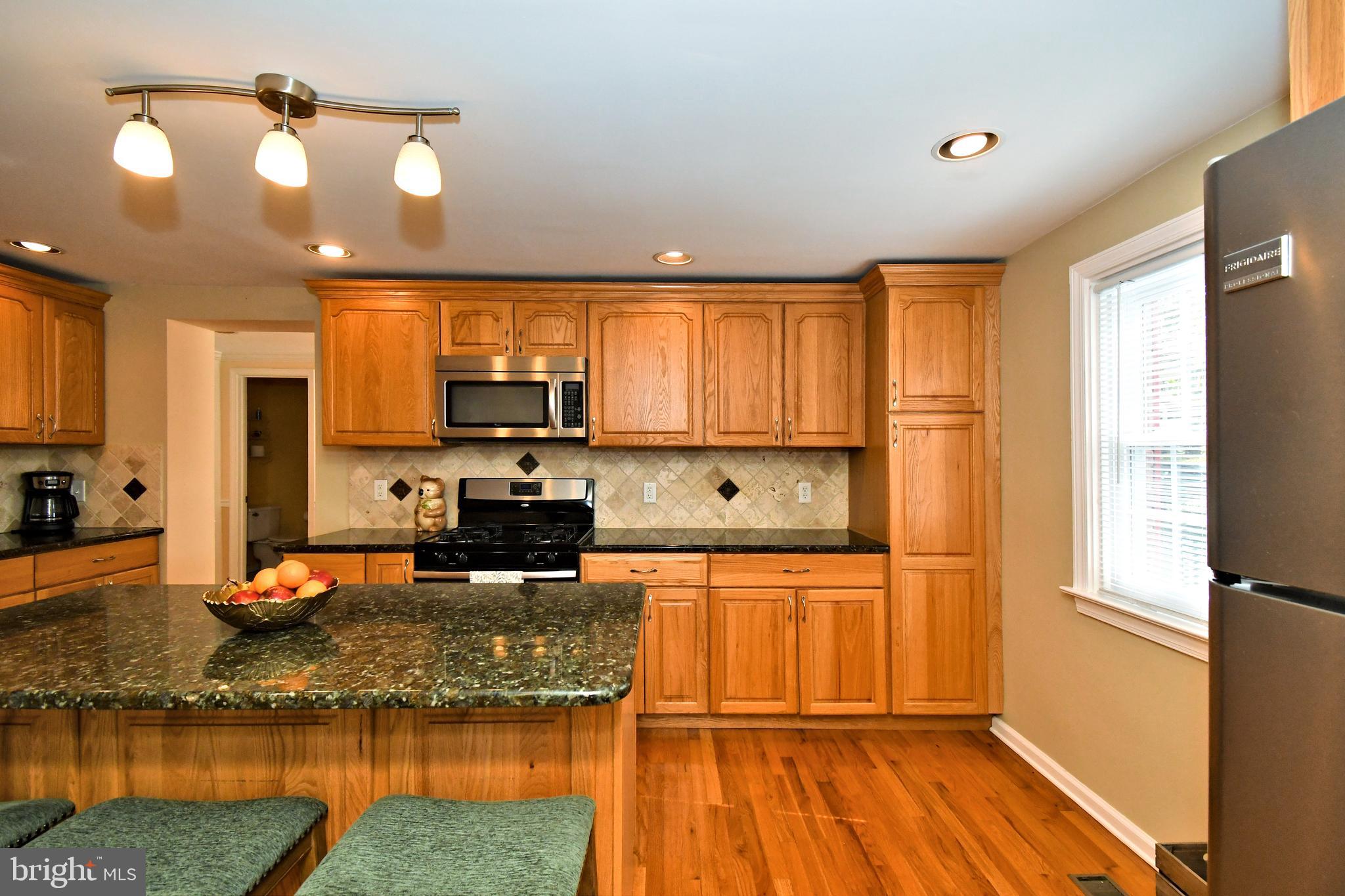 442 Oreland Mill Road Oreland, PA 19075 - Photo 9 of 68 a kitchen with stainless steel appliances granite countertop a refrigerator and a stove top oven