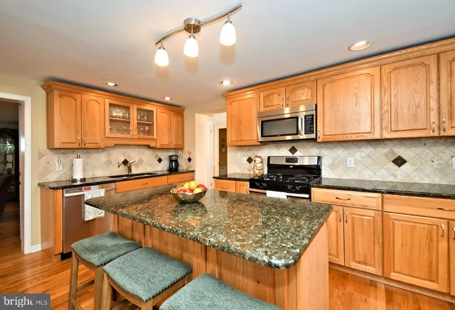 a kitchen with sink refrigerator and microwave