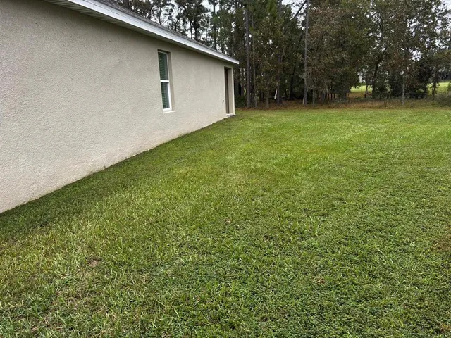 a backyard of a house with lots of green space