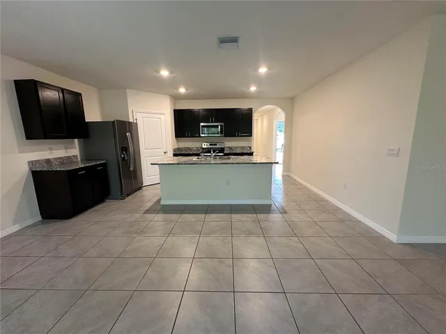 a view of kitchen with microwave cabinets and refrigerator