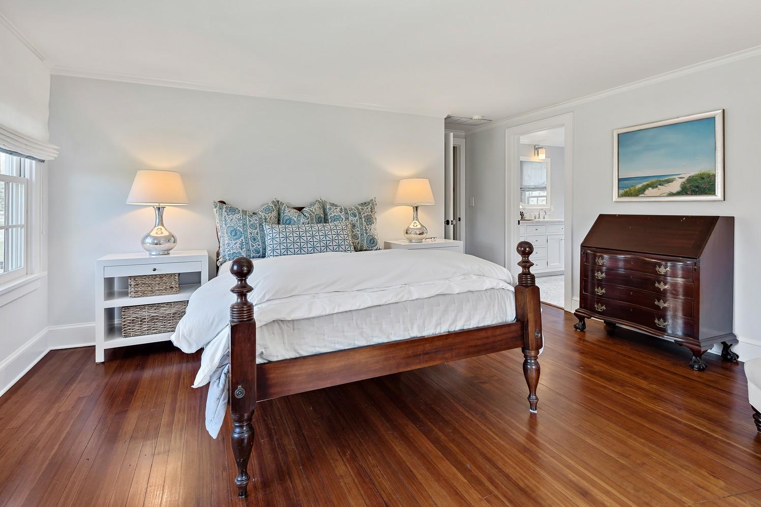 9 Beach Drive Darien, CT 06820 - Photo 30 of 39 a bedroom with a bed a dresser and wooden floor