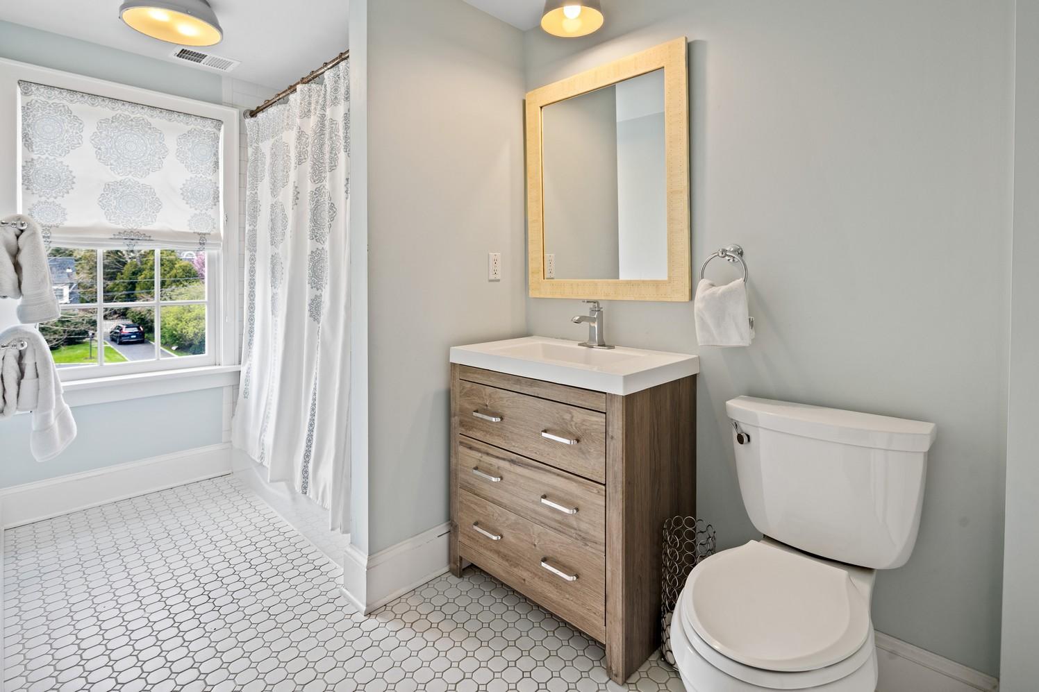 9 Beach Drive Darien, CT 06820 - Photo 35 of 39 a bathroom with a toilet a sink and a mirror