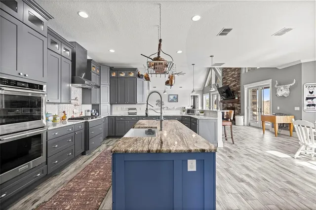 a living room with stairs and a fireplace with wooden floor