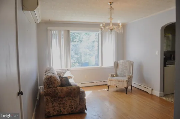 a living room with furniture and a chandelier