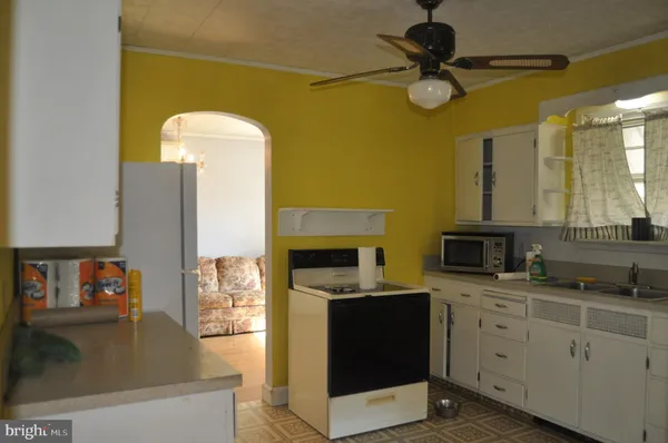 a kitchen with a sink appliances and cabinets