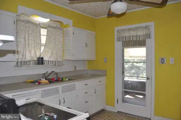 a kitchen with a sink and cabinets