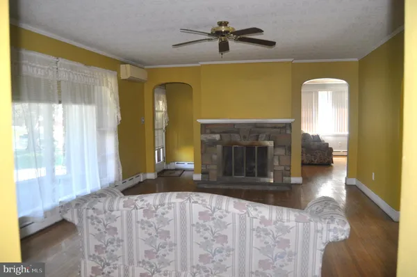 a view of living room with furniture and a fireplace