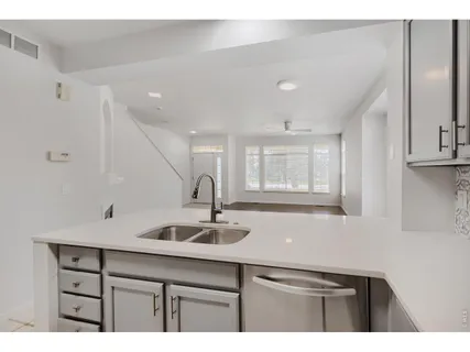 a kitchen with a sink cabinets and window