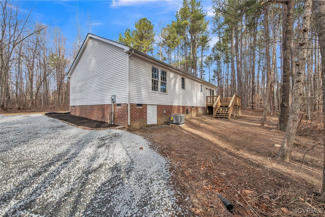 3637 Forest Grove Road Sandy Hook, VA 23153 - Photo 28 of 28 a view of a house with a yard and trees