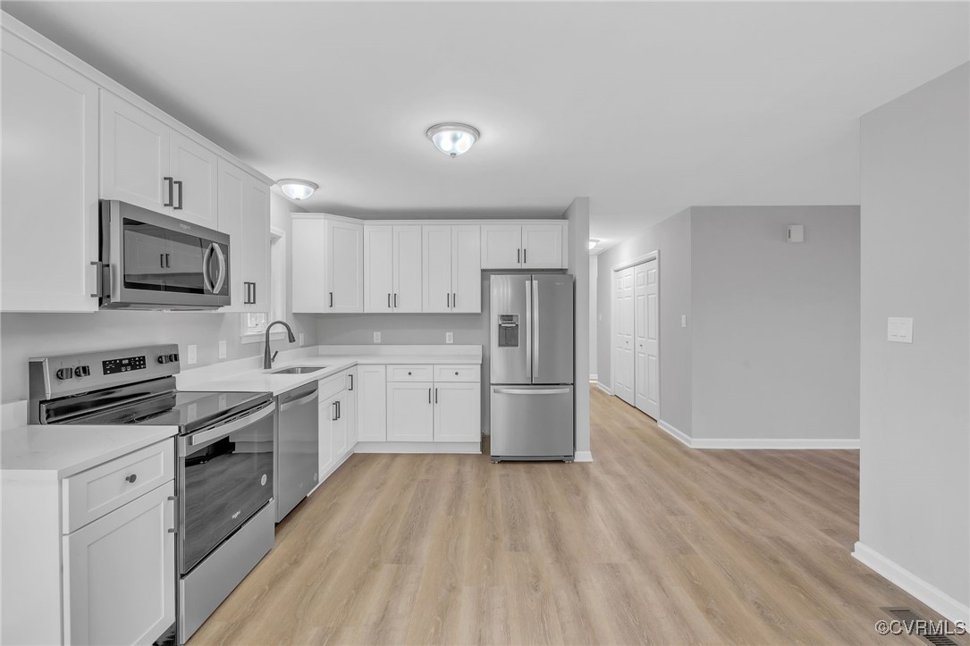 3637 Forest Grove Road Sandy Hook, VA 23153 - Photo 8 of 28 a kitchen with white cabinets stainless steel appliances and sink