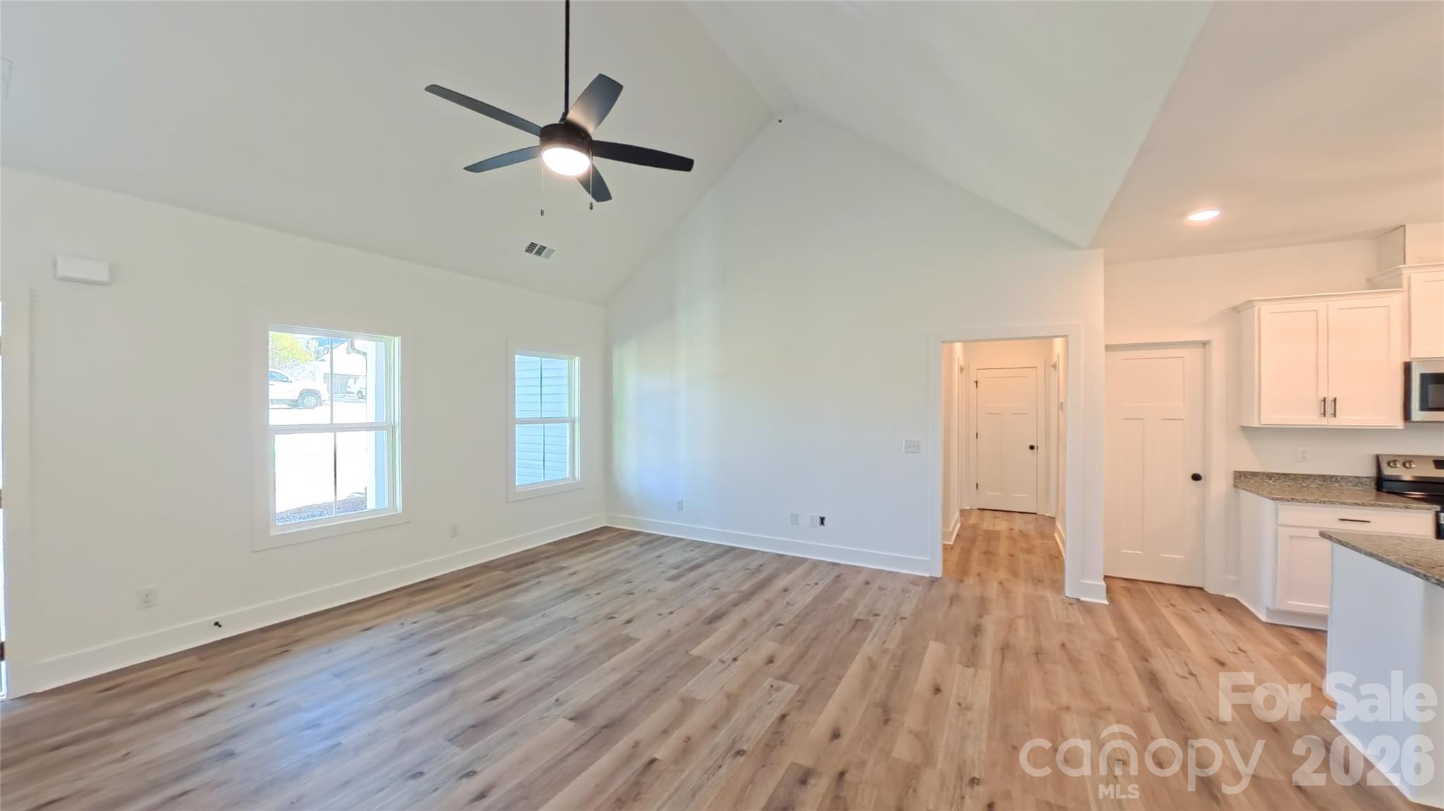 4018 Deerstone Lane, Unit 24 Clover, SC 29710 - Photo 17 of 48 a view of wooden floor and a chandelier fan in a room