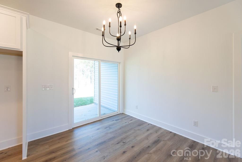 4018 Deerstone Lane, Unit 24 Clover, SC 29710 - Photo 29 of 48 a view of a room with wooden floor chandelier and a window