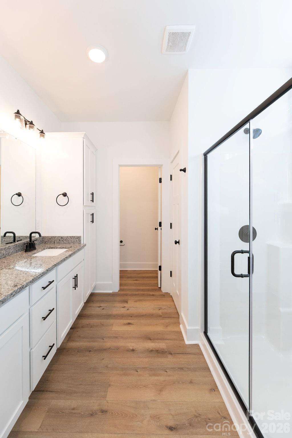 4018 Deerstone Lane, Unit 24 Clover, SC 29710 - Photo 32 of 48 a spacious bathroom with a granite countertop sink a mirror a shower and a bathtub
