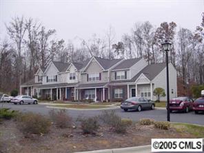 a view of a town with cars parked in front of it