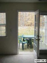 8312 Rudolph Road, Unit 8312 Charlotte, NC 28216 - Photo 2 of 8 a dining room with furniture and a floor to ceiling window